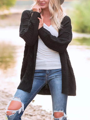 Black cable-knit open front cardigan, long sleeves.