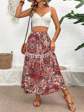 Model wearing printed elastic waist midi skirt with tassels