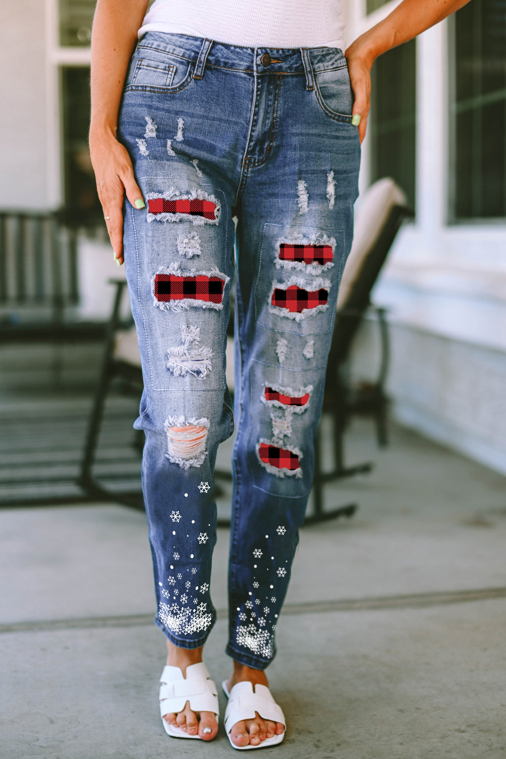 Front view of plaid snow graphic distressed jeans