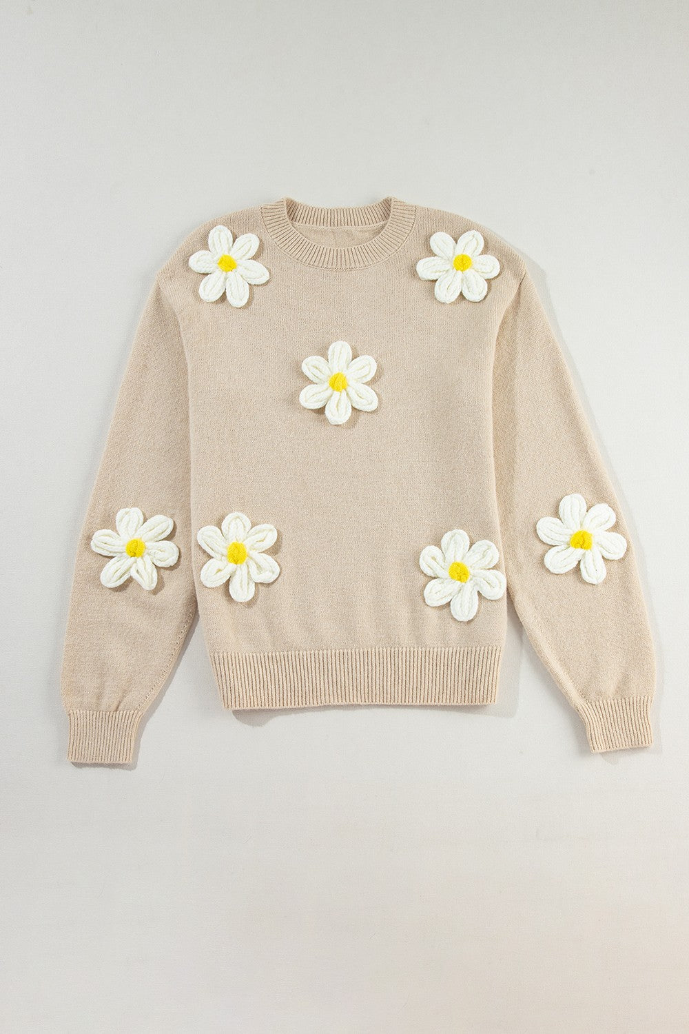 Beige sweater with white crochet flowers, round neck.