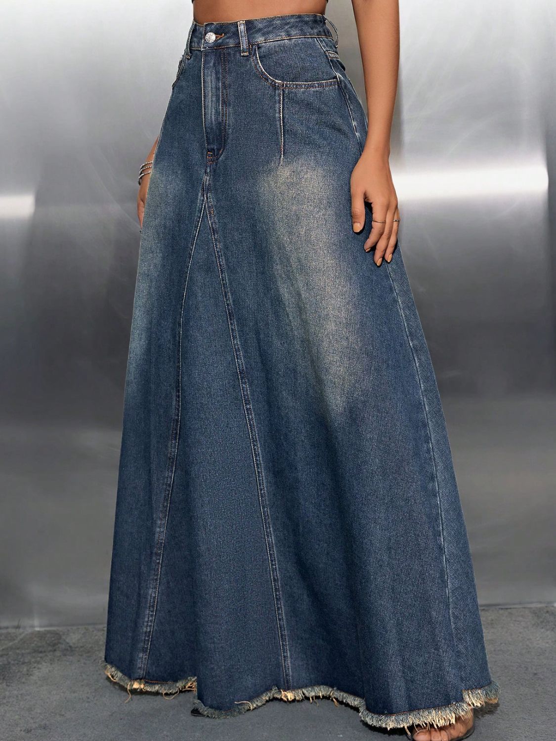 a woman wearing a denim skirt and crop top