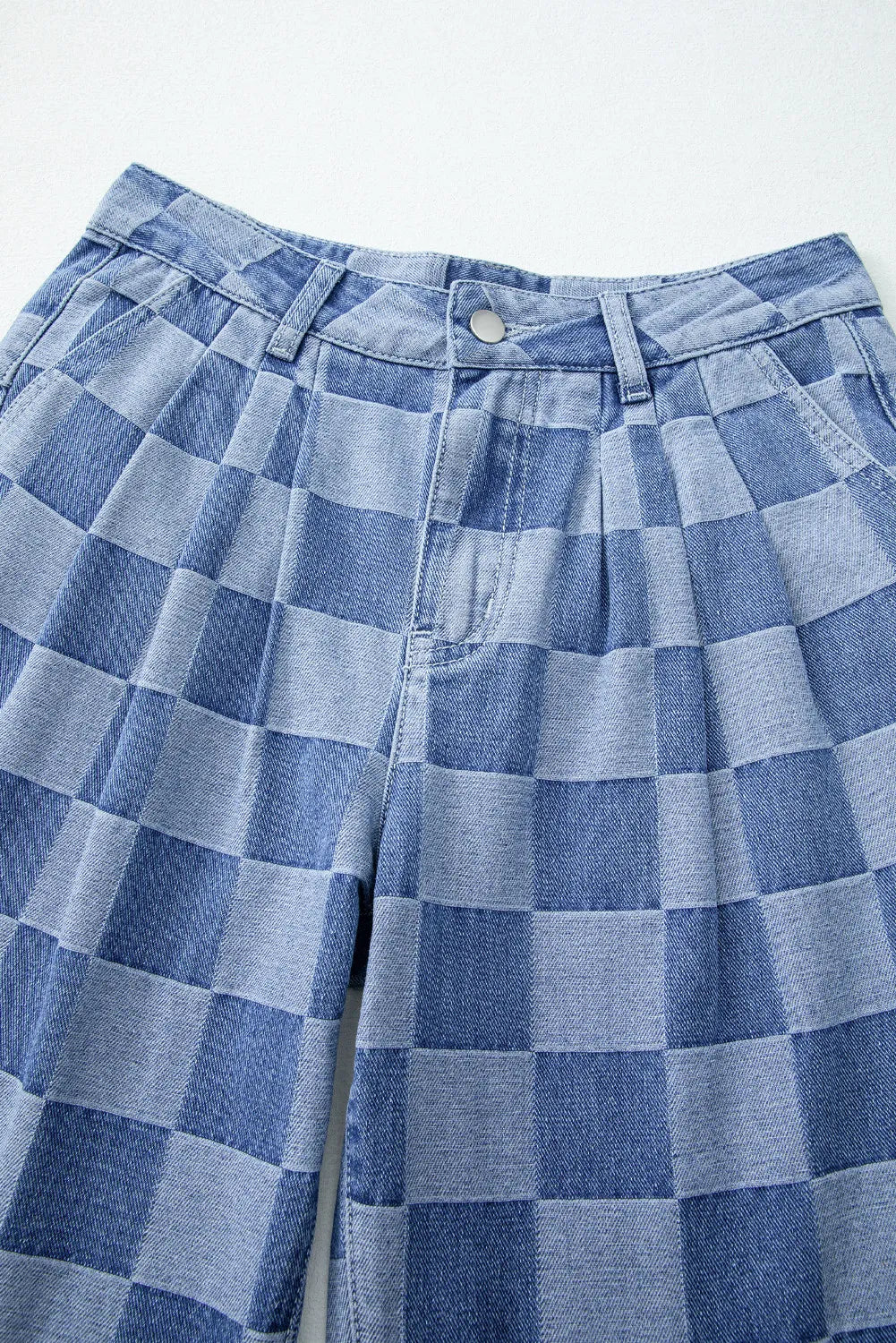 Close-up of checkered wide leg jeans with button detail