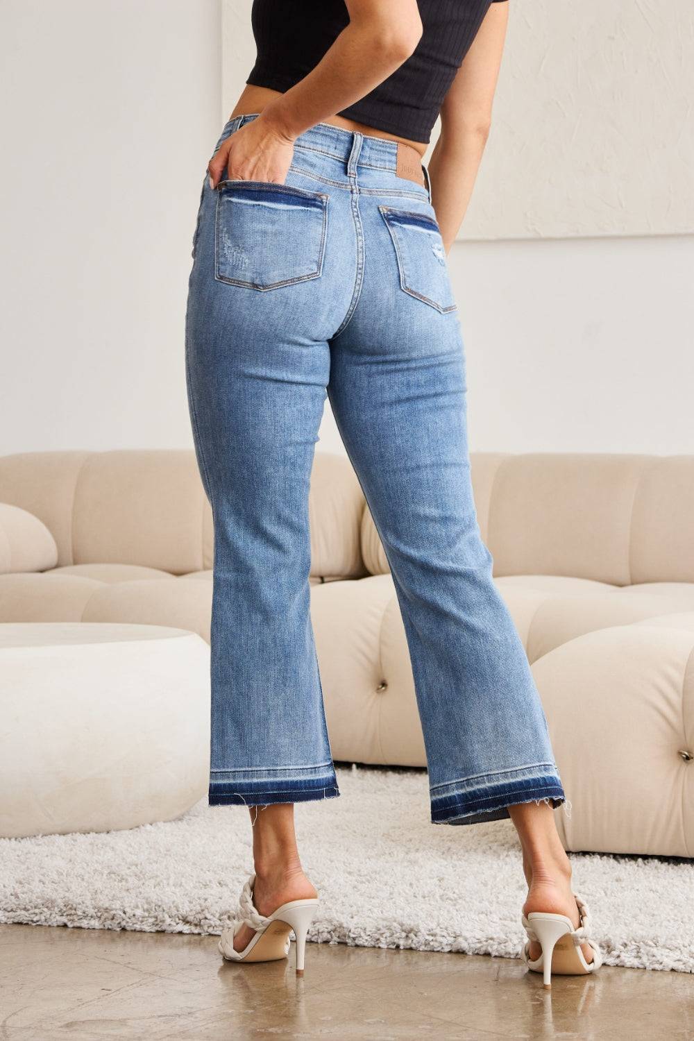 a woman standing in a living room with her back to the camera