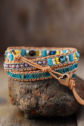 Colorful heart layered bracelet on a rock