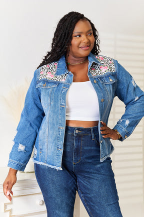 Plus size model in leopard floral denim jacket.