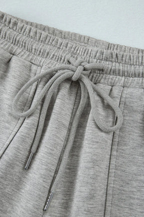 Close-up of gray drawstring waistband on active pants