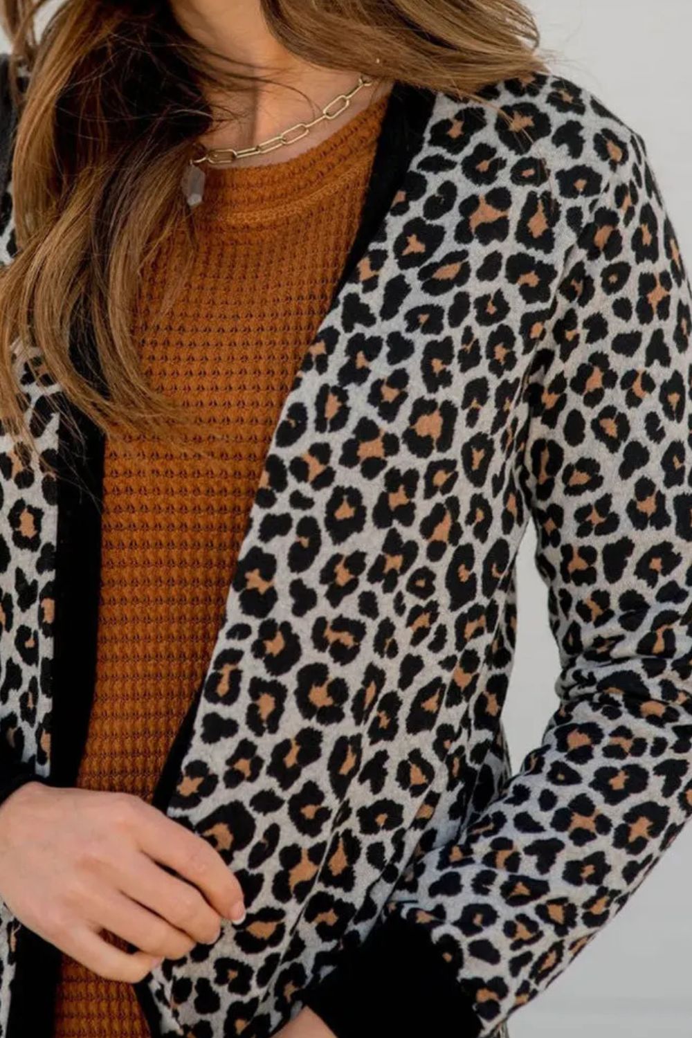 Close-up of leopard print cover-up with black trim