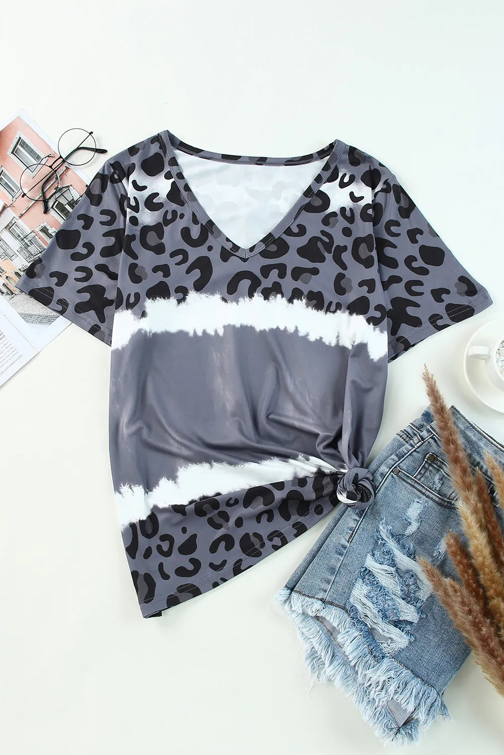 Leopard V-Neck Short Sleeve T-Shirt laid flat with denim shorts