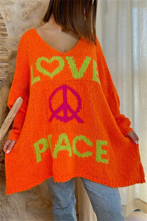 Orange V-neck sweater with peace graphic and love text