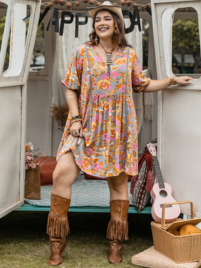 Plus size ruched printed mini dress with half sleeves, styled with boots