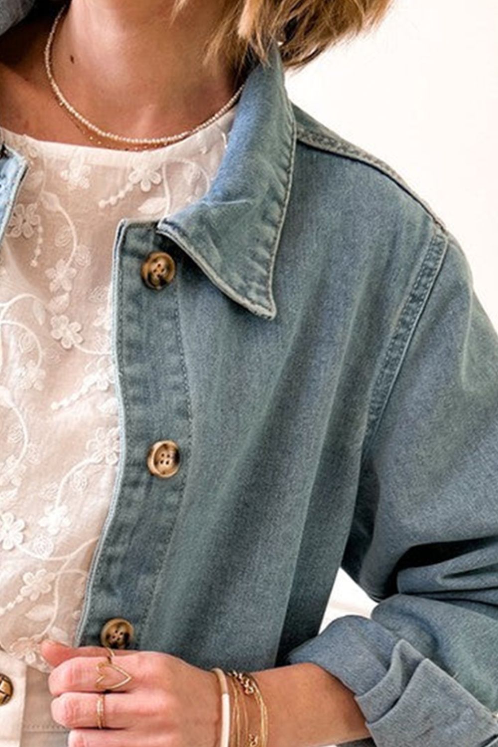 Close-up of button details on denim jacket