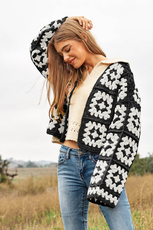 Black and white floral crochet cardigan, open knit design.