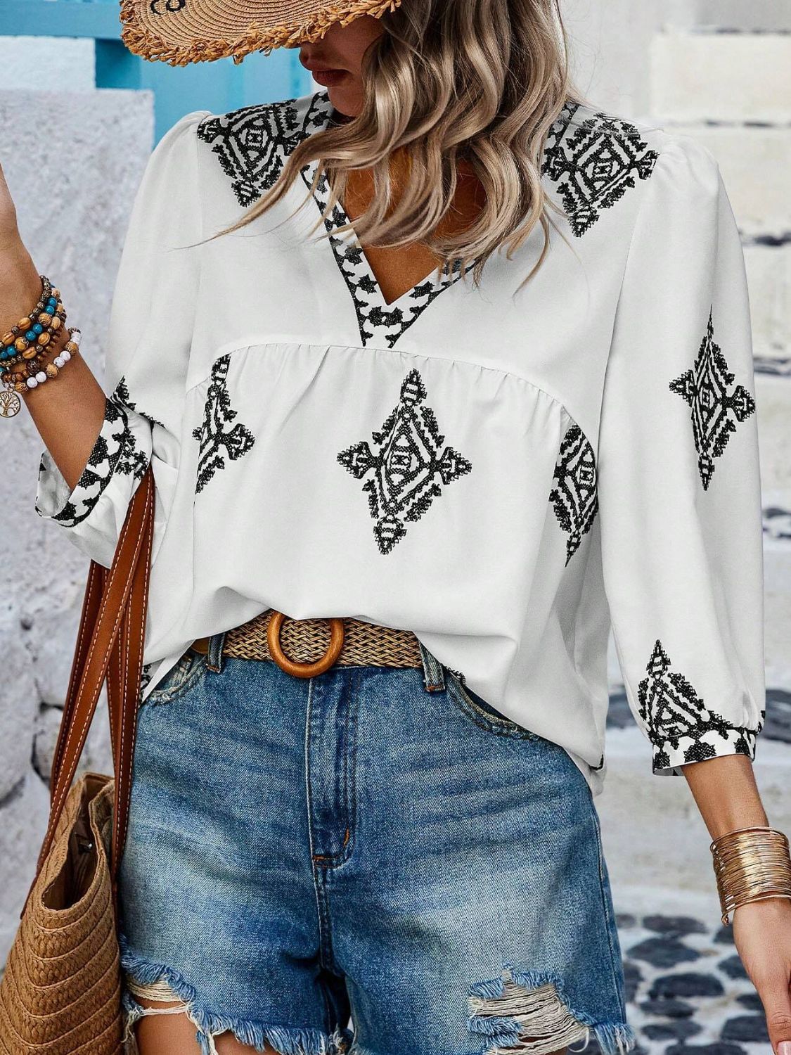 White blouse with black print and V-neck design