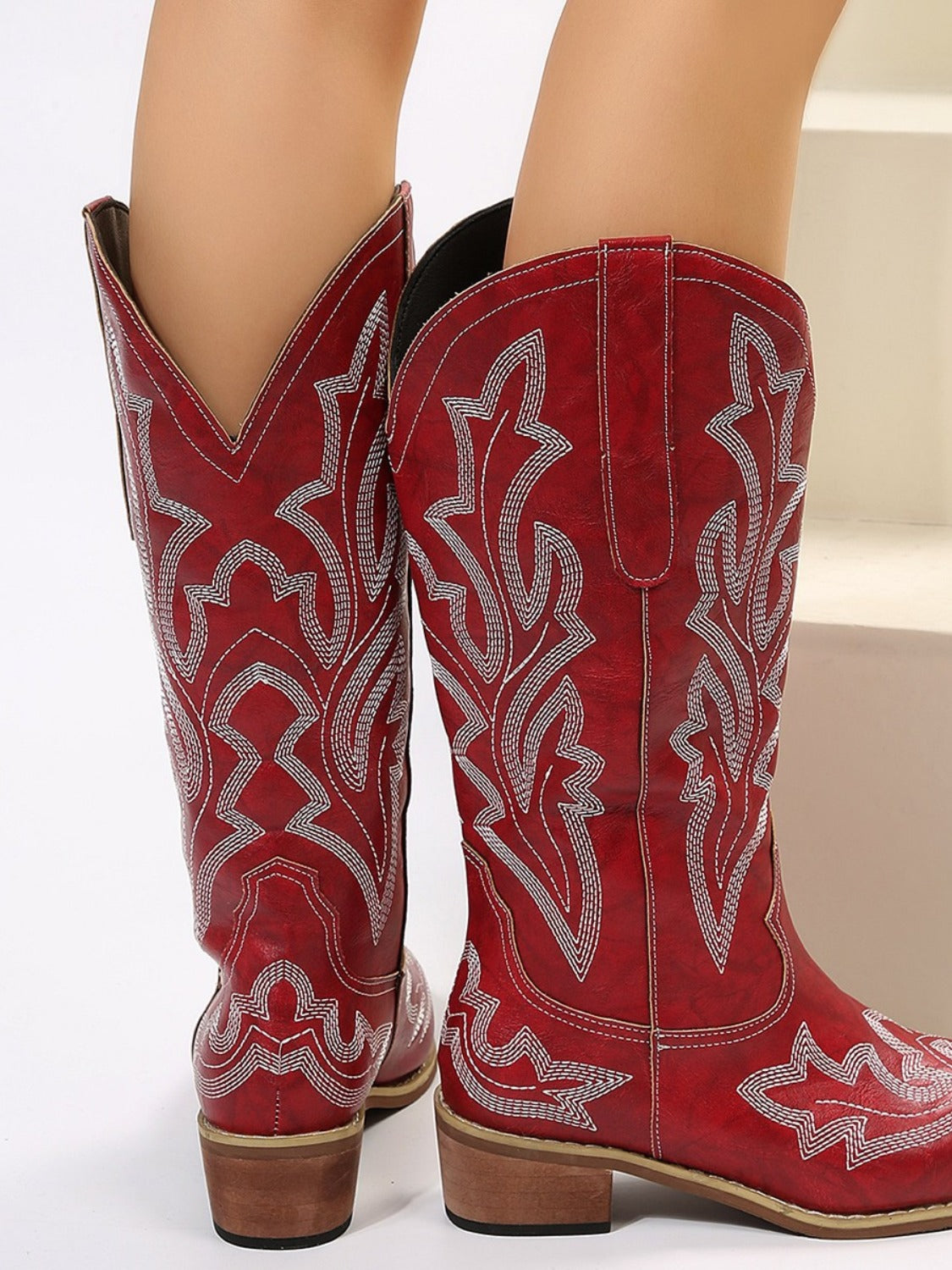 Back view of red PU leather embroidered geometric boots