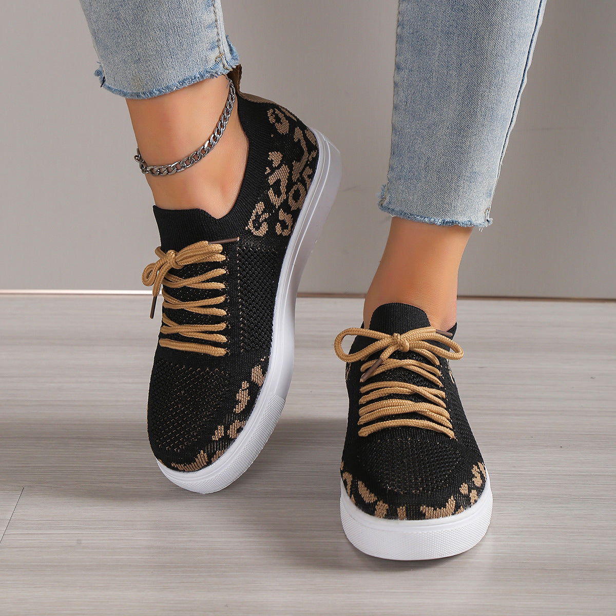 Black lace-up leopard flat sneakers with tan laces