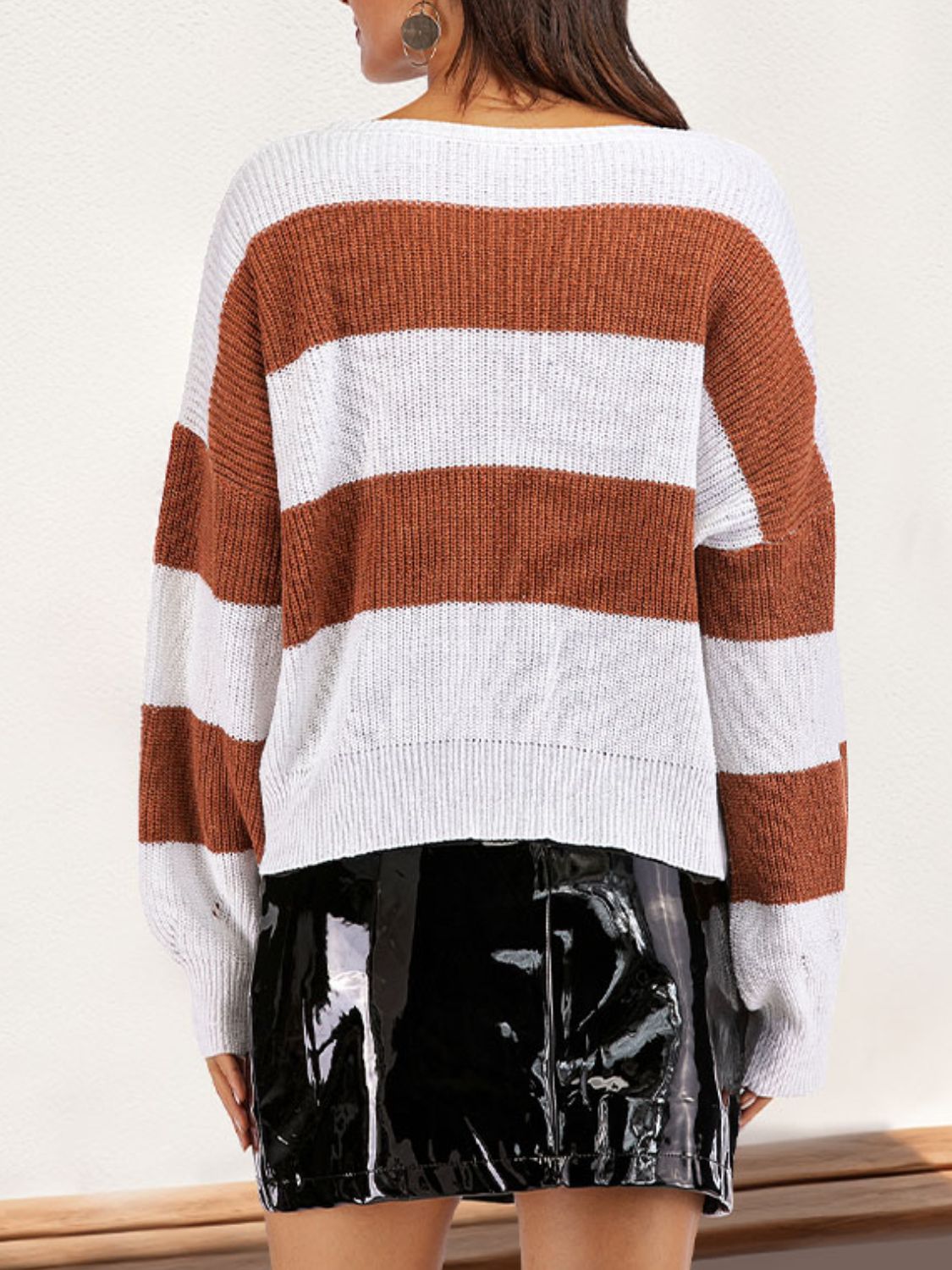 Back view of color block sweater with brown and white stripes