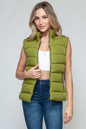 Front view of zip up turtleneck vest with pockets.