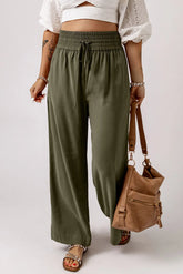 Olive smocked high waist wide leg pants, front view