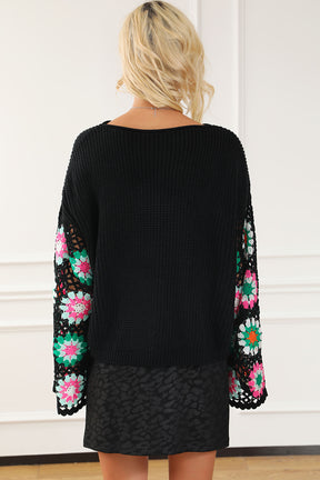 Back view of black crochet knit top with colorful sleeves