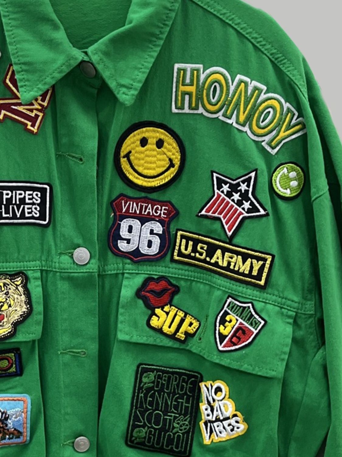 Detailed view of patches on green jacket.