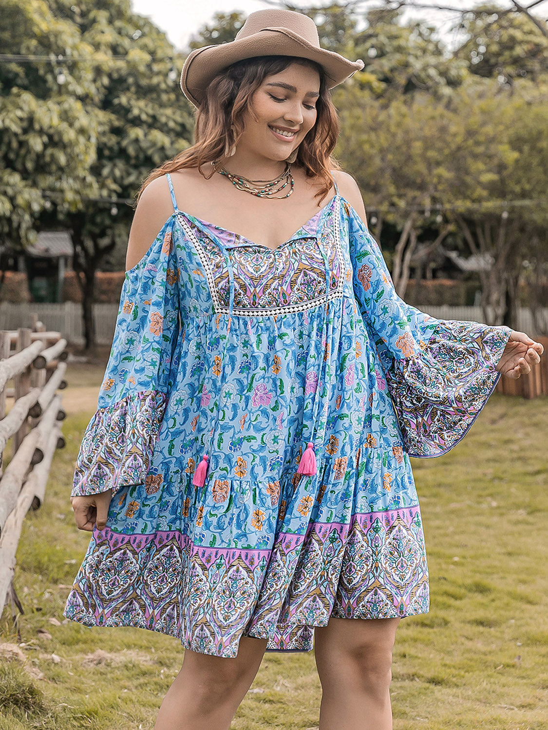 Blue plus size printed mini dress with long sleeves, front view.