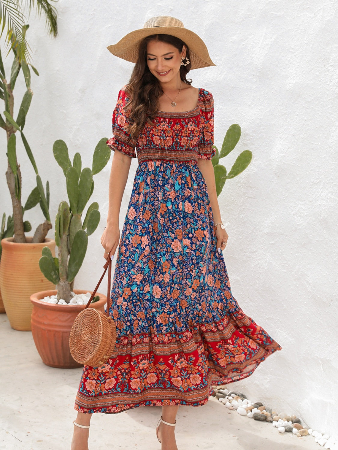 Red floral flounce sleeve midi dress with straw handbag.