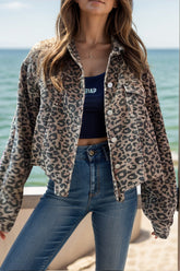 a woman wearing a leopard print jacket and jeans