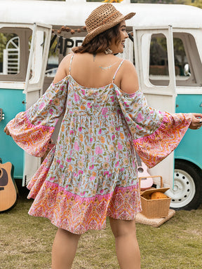 Plus size printed mini dress with long sleeves, back view.