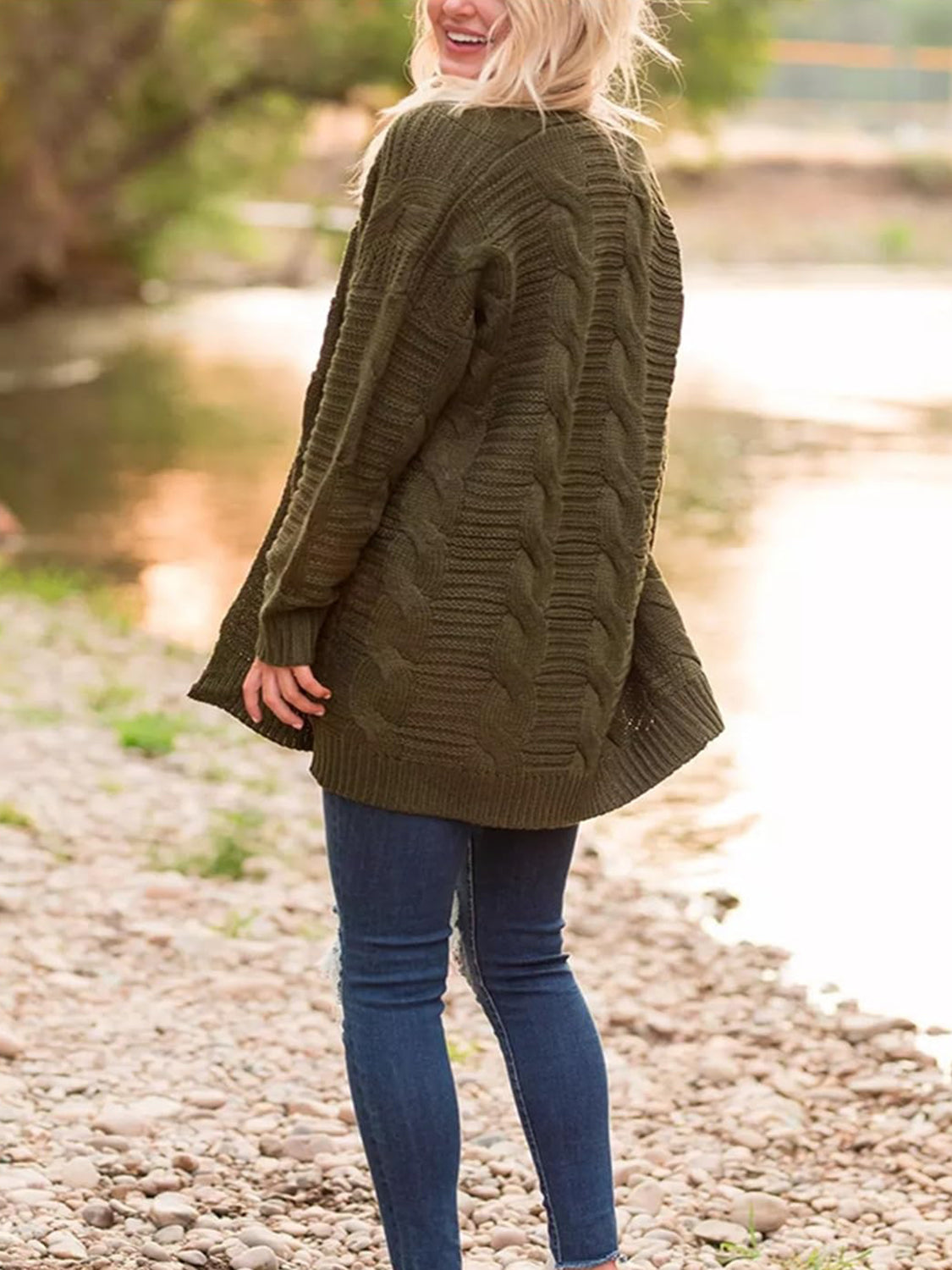 Back view of army green cable-knit open front cardigan.