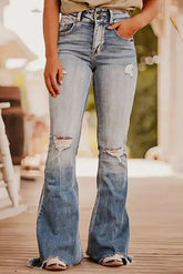 Distressed raw hem wide leg jeans worn outdoors