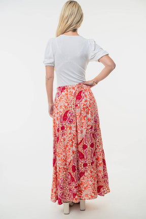 a woman in a long skirt with a white shirt on