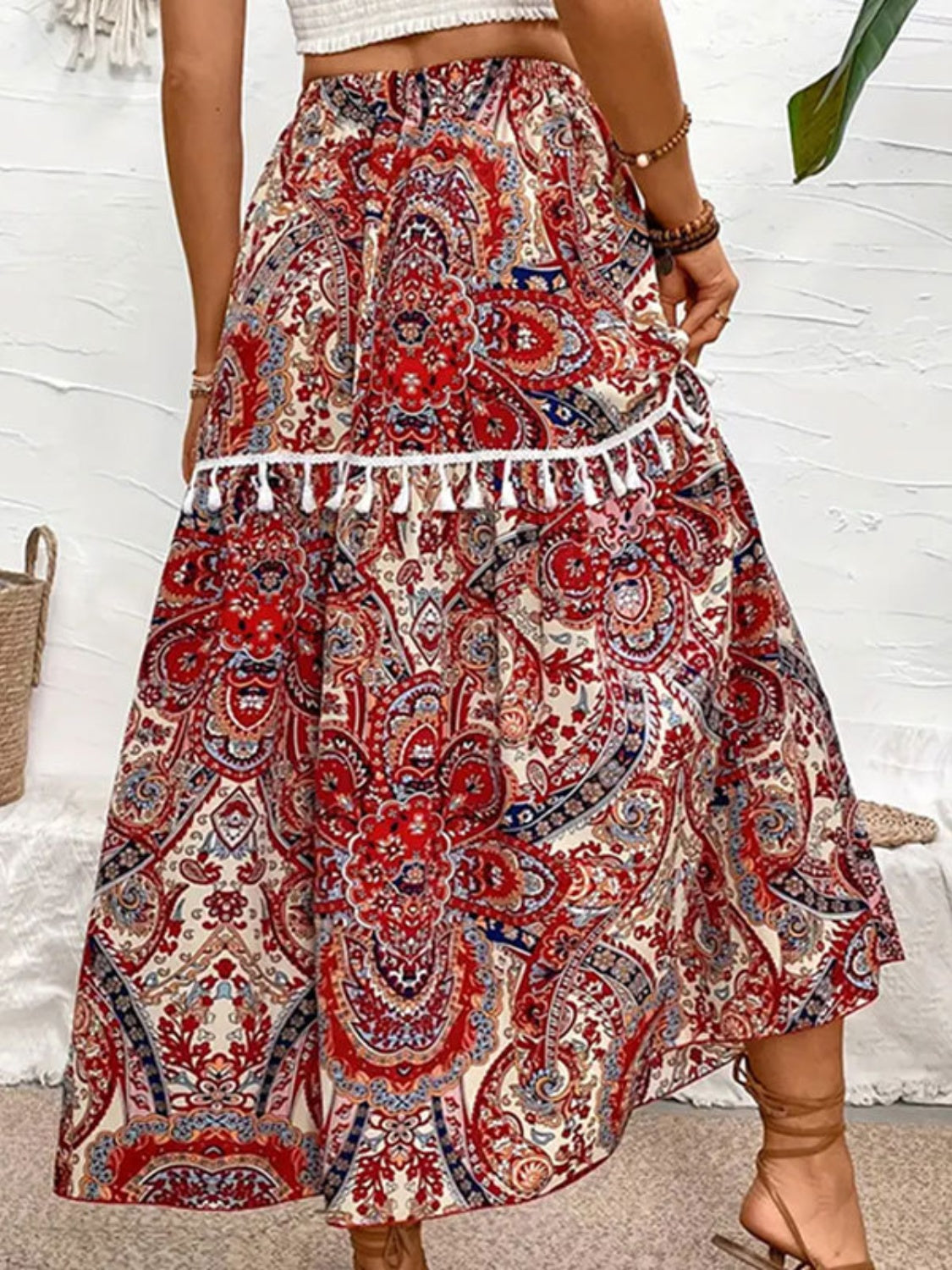 Back view of printed elastic waist midi skirt with tassels