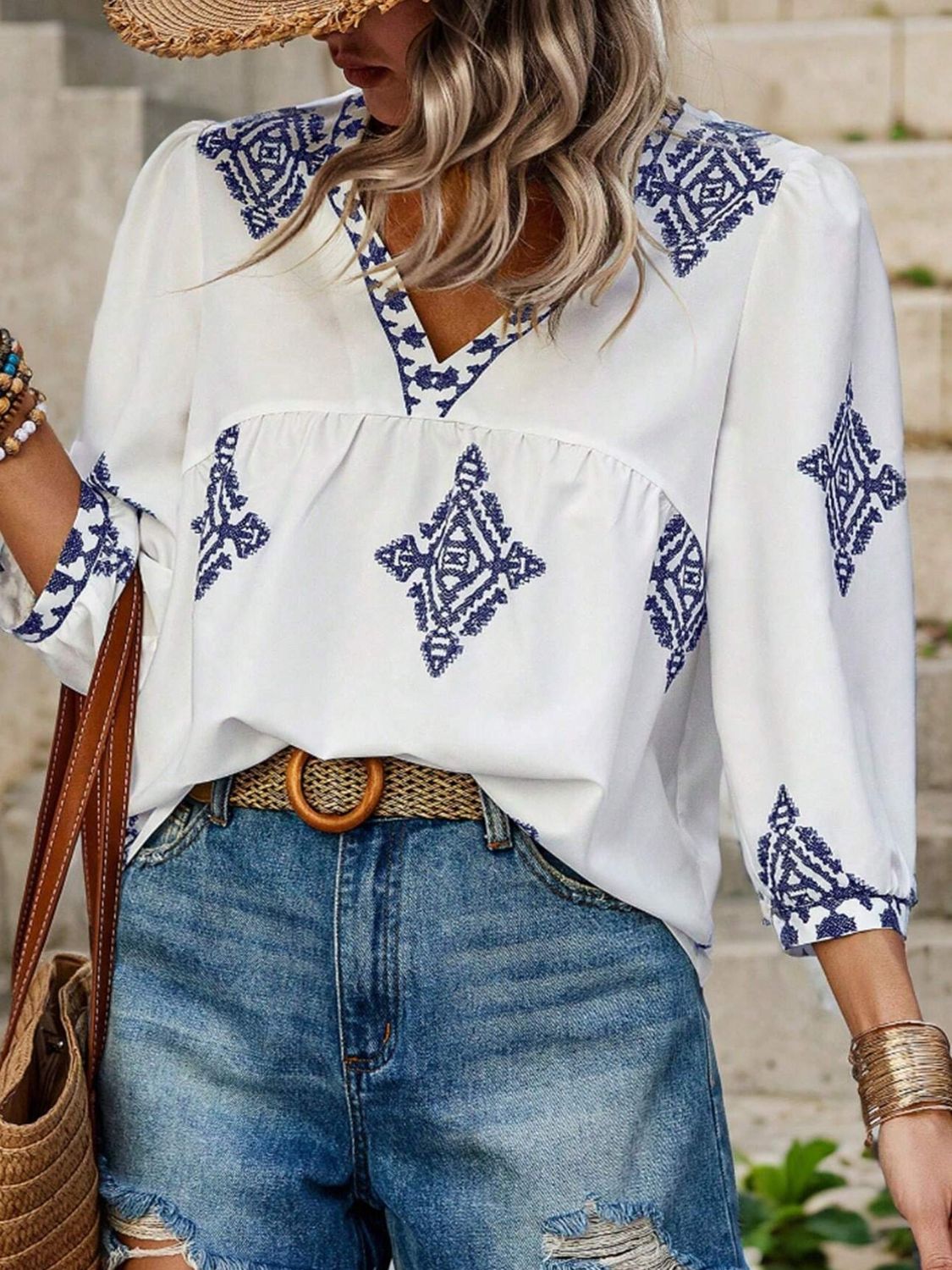 White blouse with blue print and V-neck design