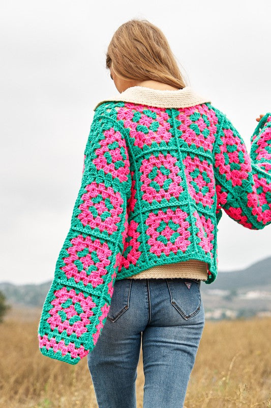 Back view of pink and green crochet cardigan.