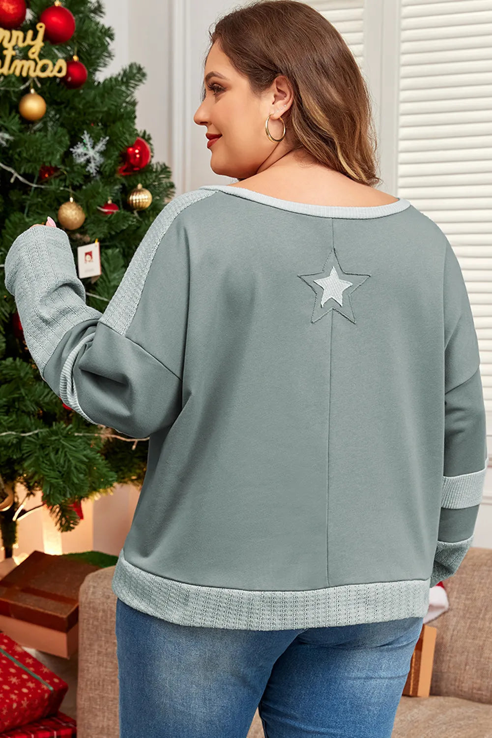 Back view of plus size sage top with star detail