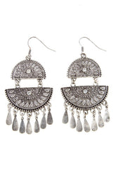 a pair of earrings with dangling drops