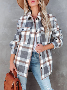 Woman wearing plaid collared neck long sleeve jacket.