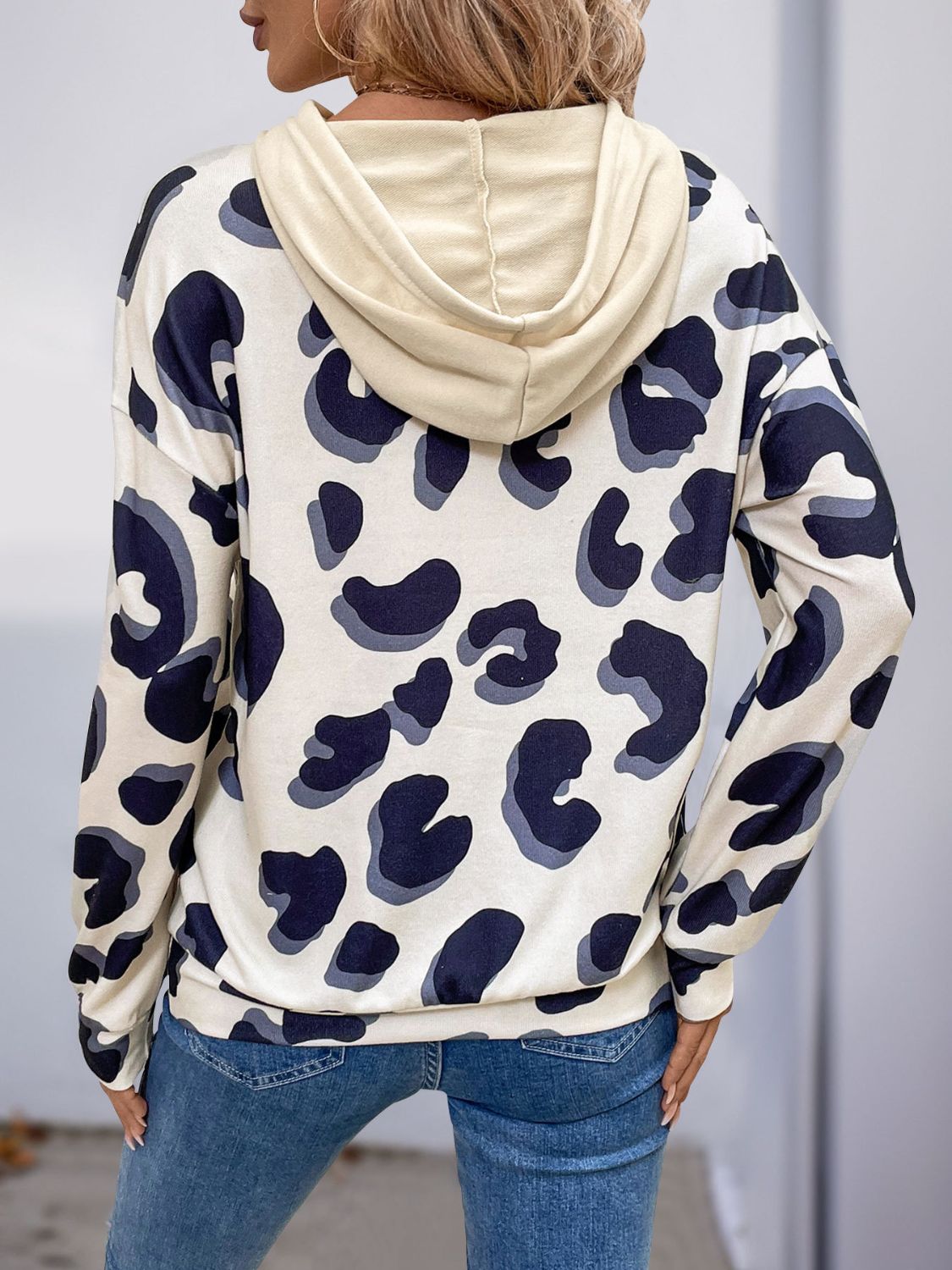 Back view of Perfee drawstring faux layered hoodie with leopard print