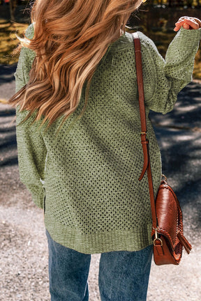 Back view of green openwork V-neck sweater