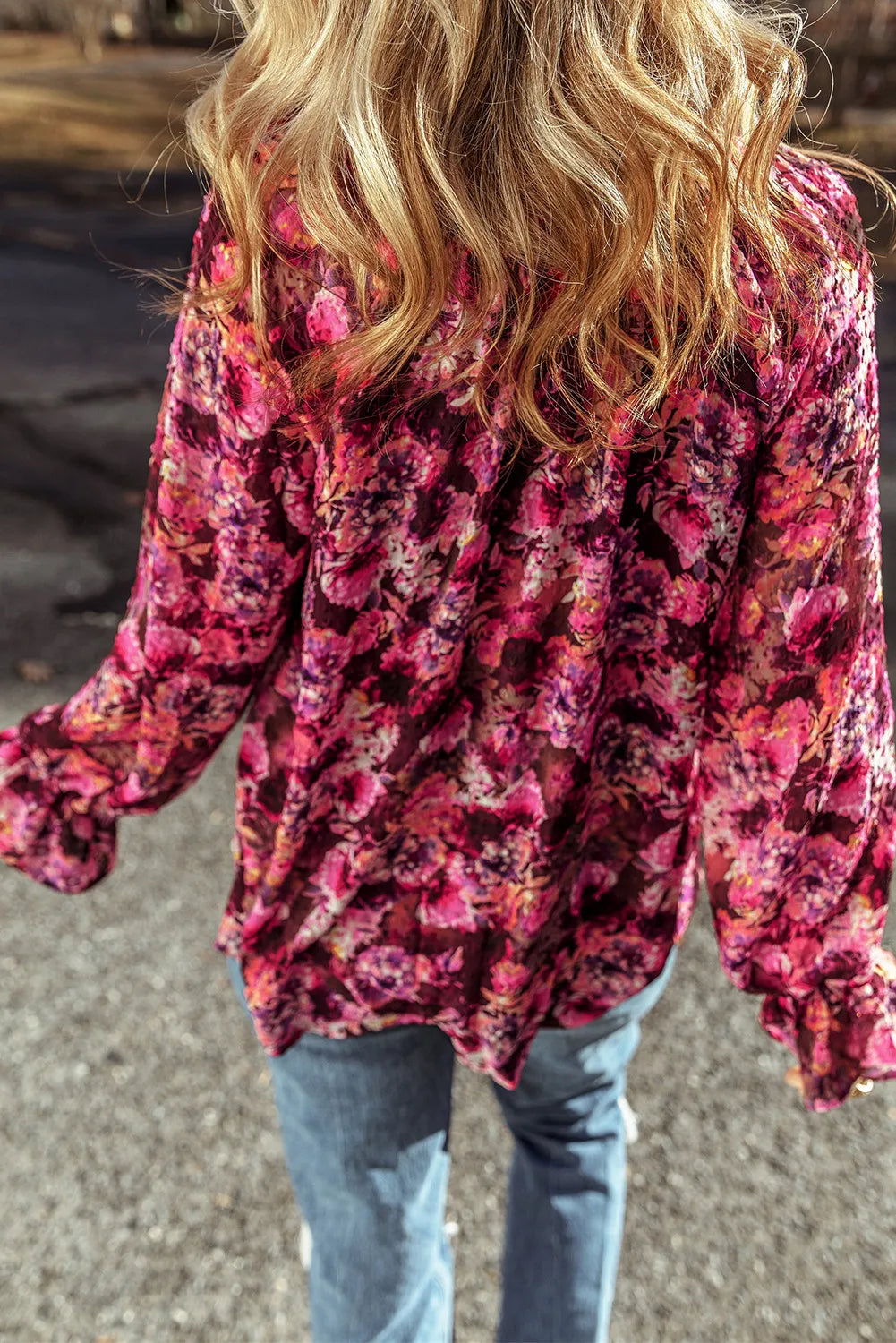 Back view of floral printed tie neck flounce sleeve blouse