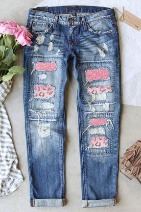 Front view of leopard patch distressed straight leg jeans