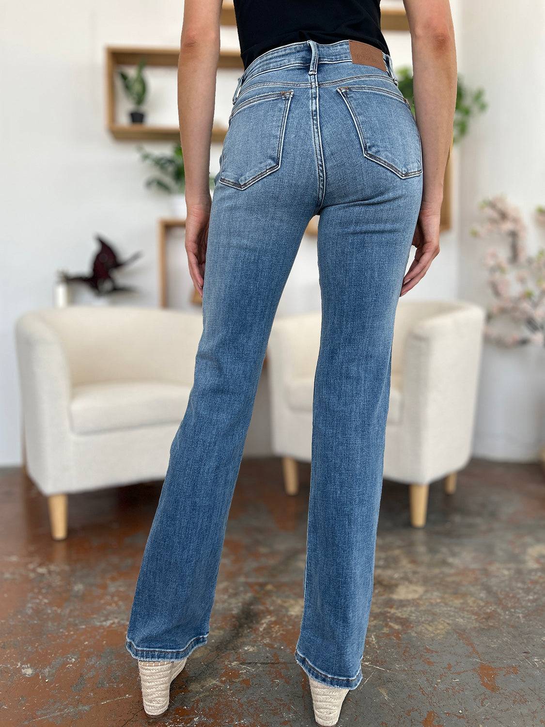 a woman in a black shirt and jeans