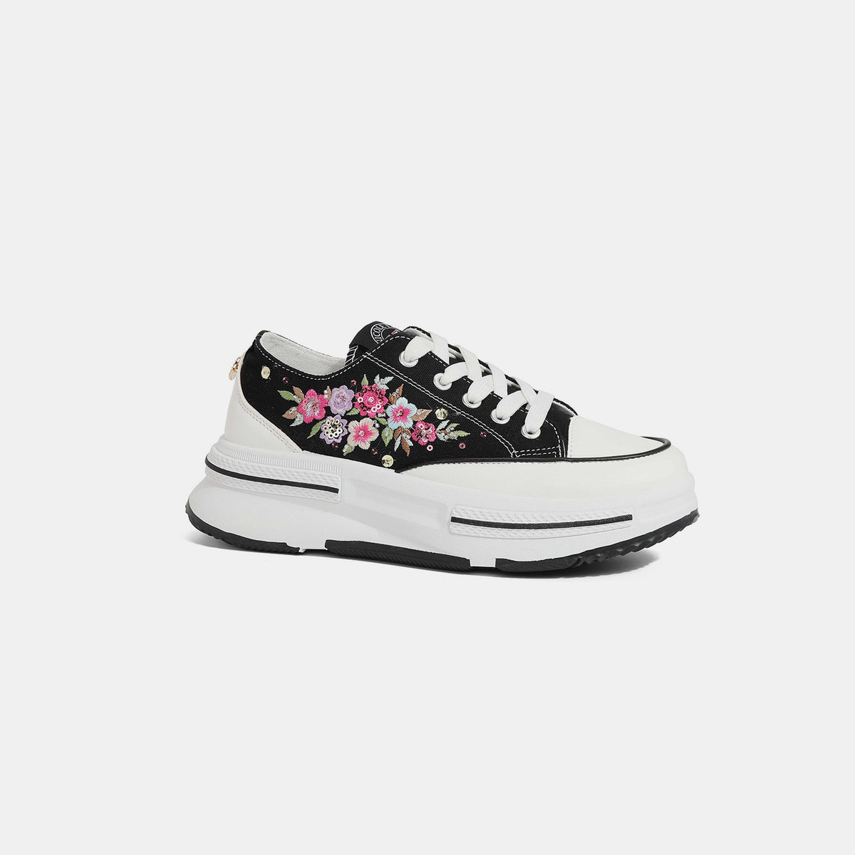 Nicole Lee USA black sneakers with floral embroidery, side view.