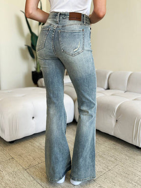 a woman standing in a living room with her back to the camera