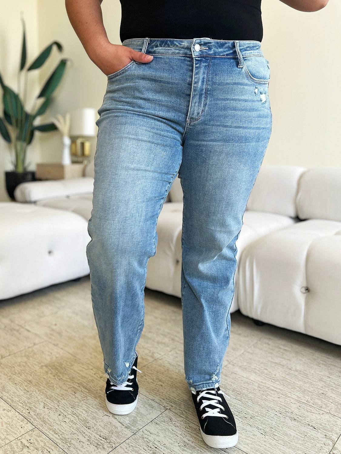 a woman standing in a living room with her hands on her hips