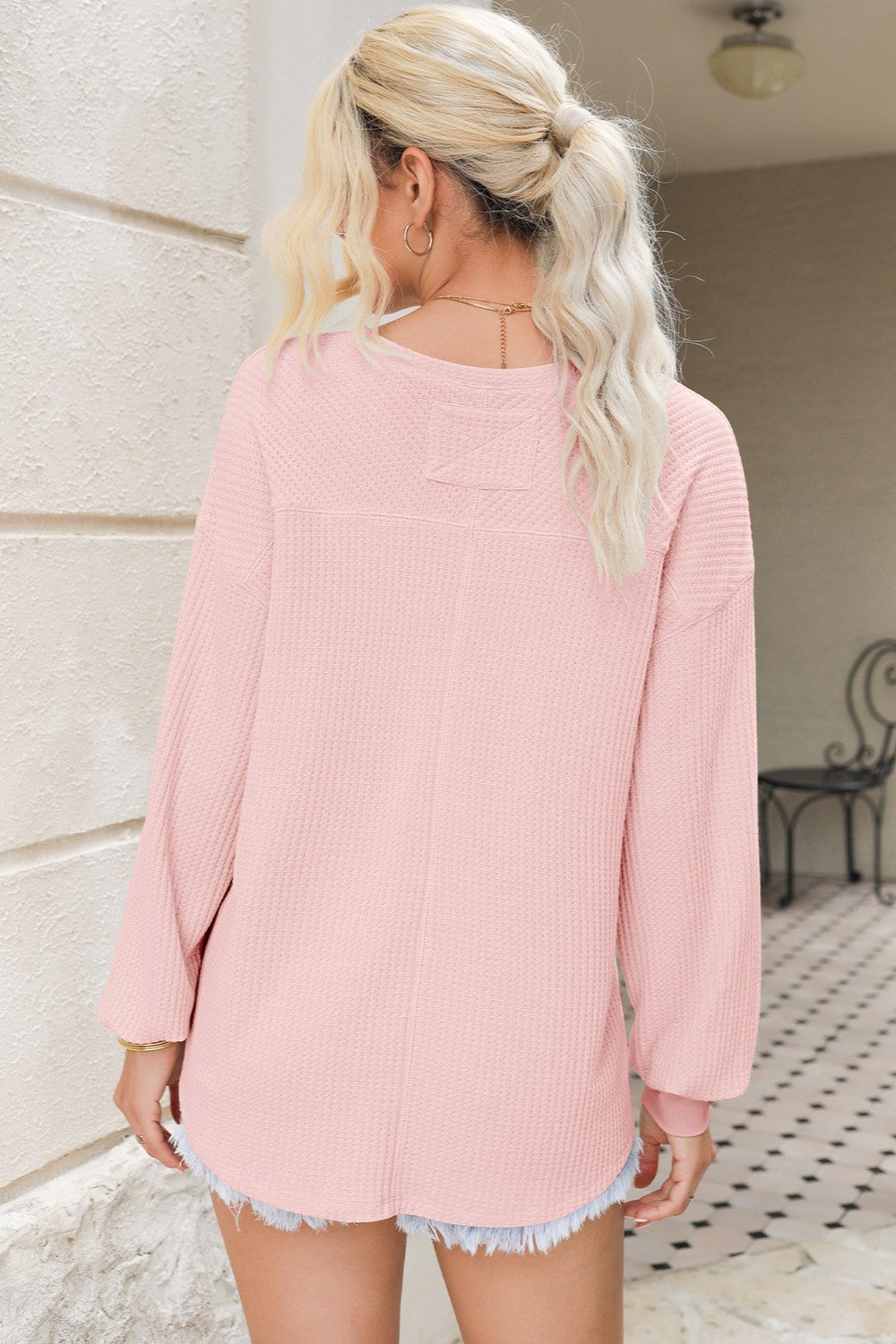 Back view of pink waffle-knit V-neck long sleeve top