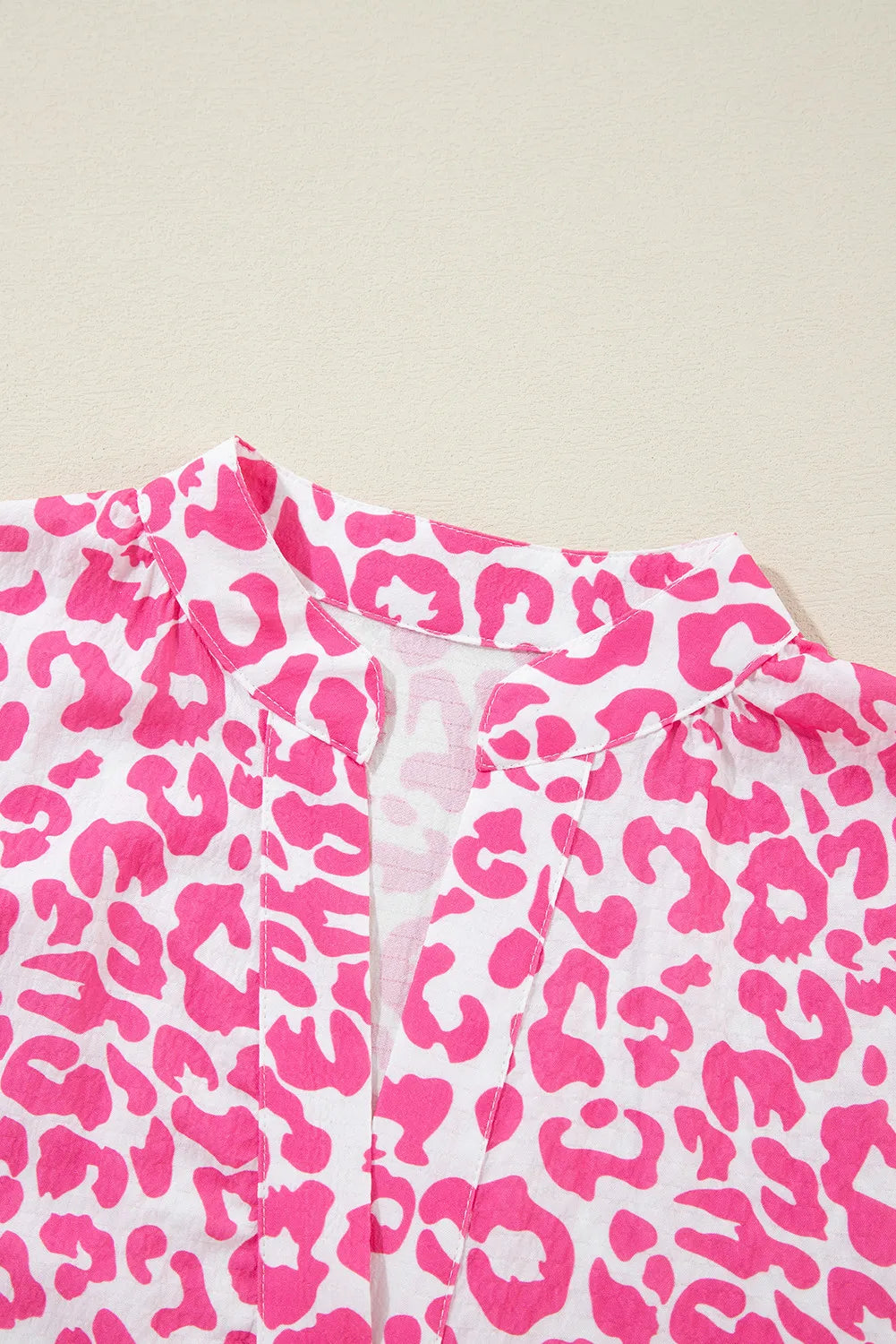 Close-up of leopard print notched neckline dress fabric