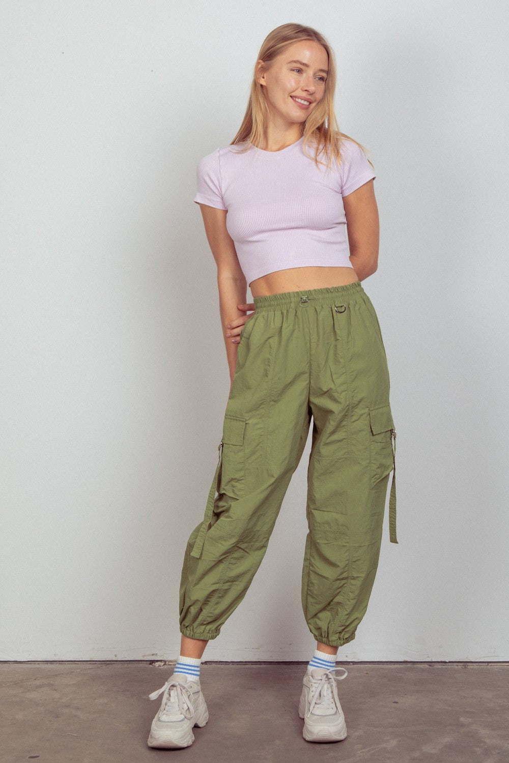 Model wearing green elastic waist woven cargo pants