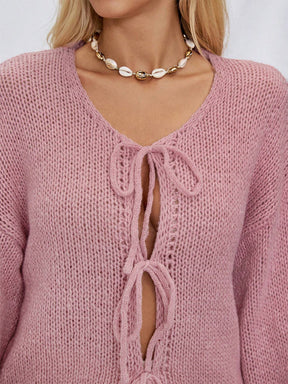 Close-up of dusty pink cardigan with tie details