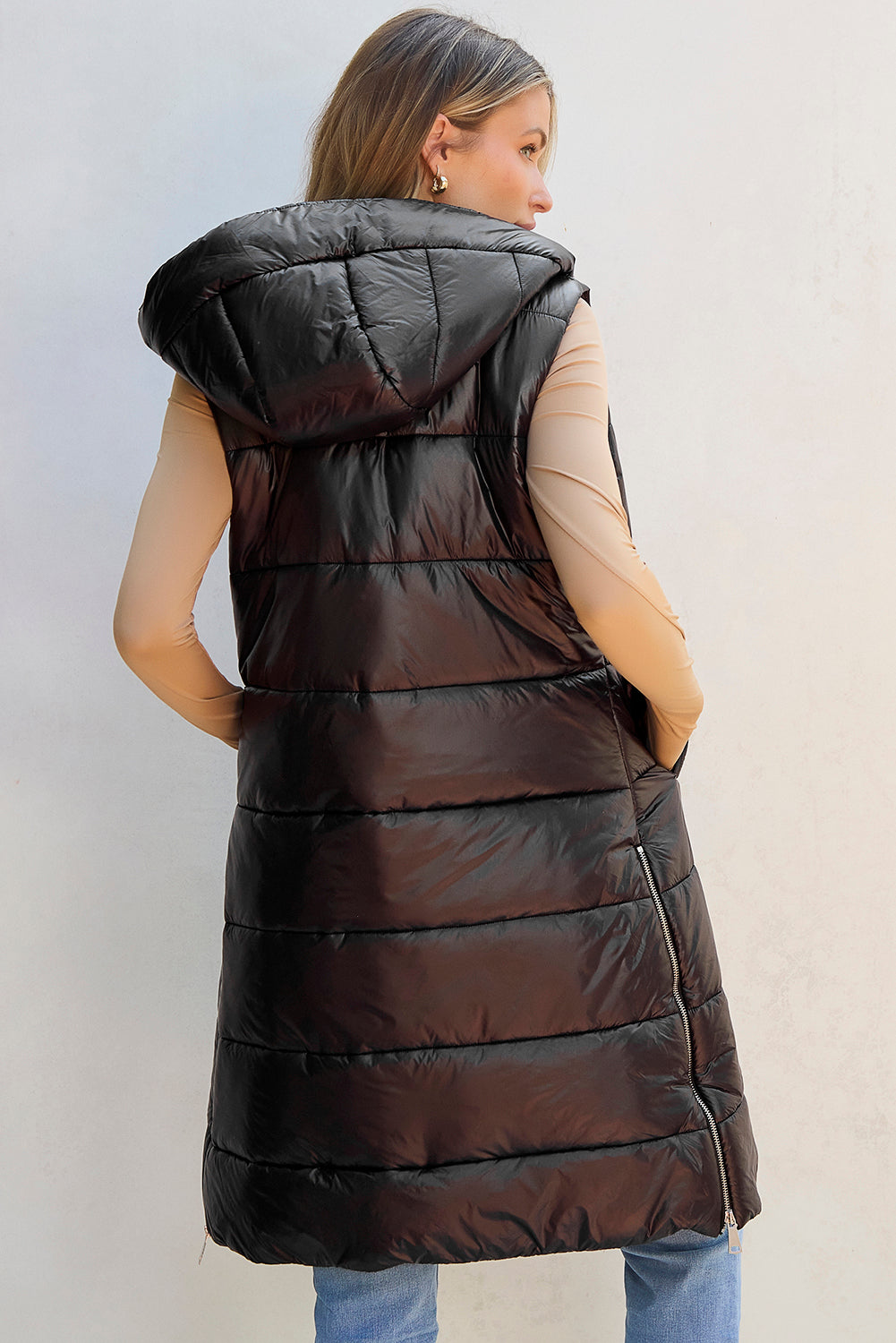 Black longline hooded sleeveless puffer vest, back view